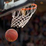 A basketball drops through a hoop.
