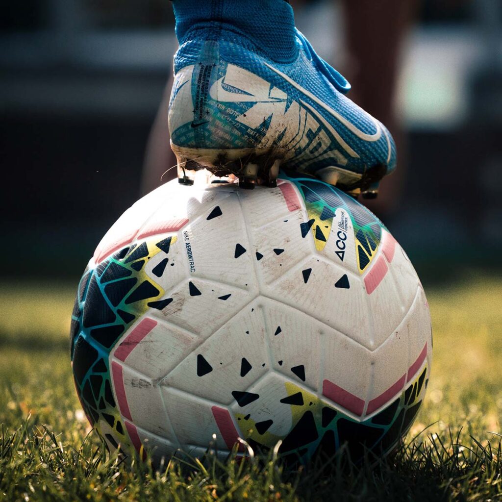 A football boot resting on a football