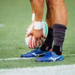 Rugby player holds a rugby ball