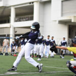 Softball player hitting ball