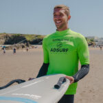 Cyril holding surfboard