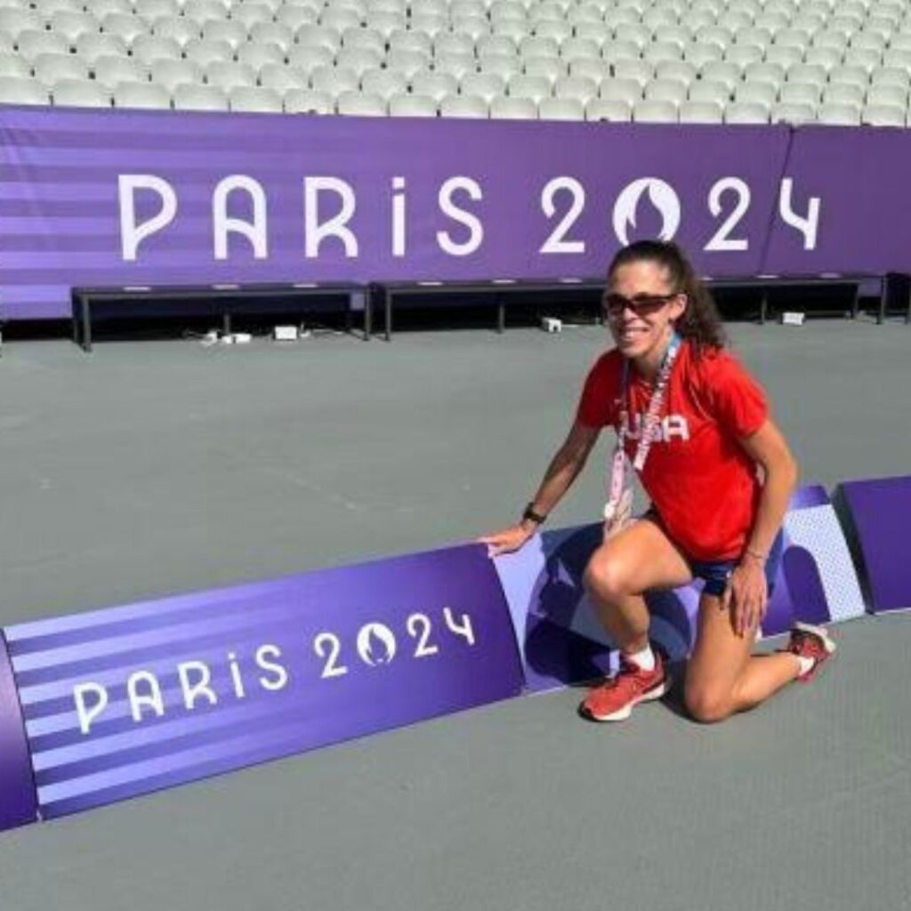 Kaitlin Bounds poses with Paris 2024 sign