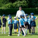 Darren on cricket pitch with kids